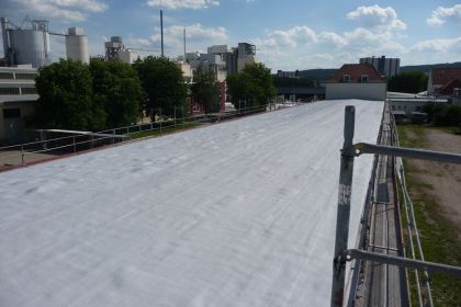 Roof renovation of an old foam roof with the liquid plastic PURelastik and reinforcing fleece in full reinforcement